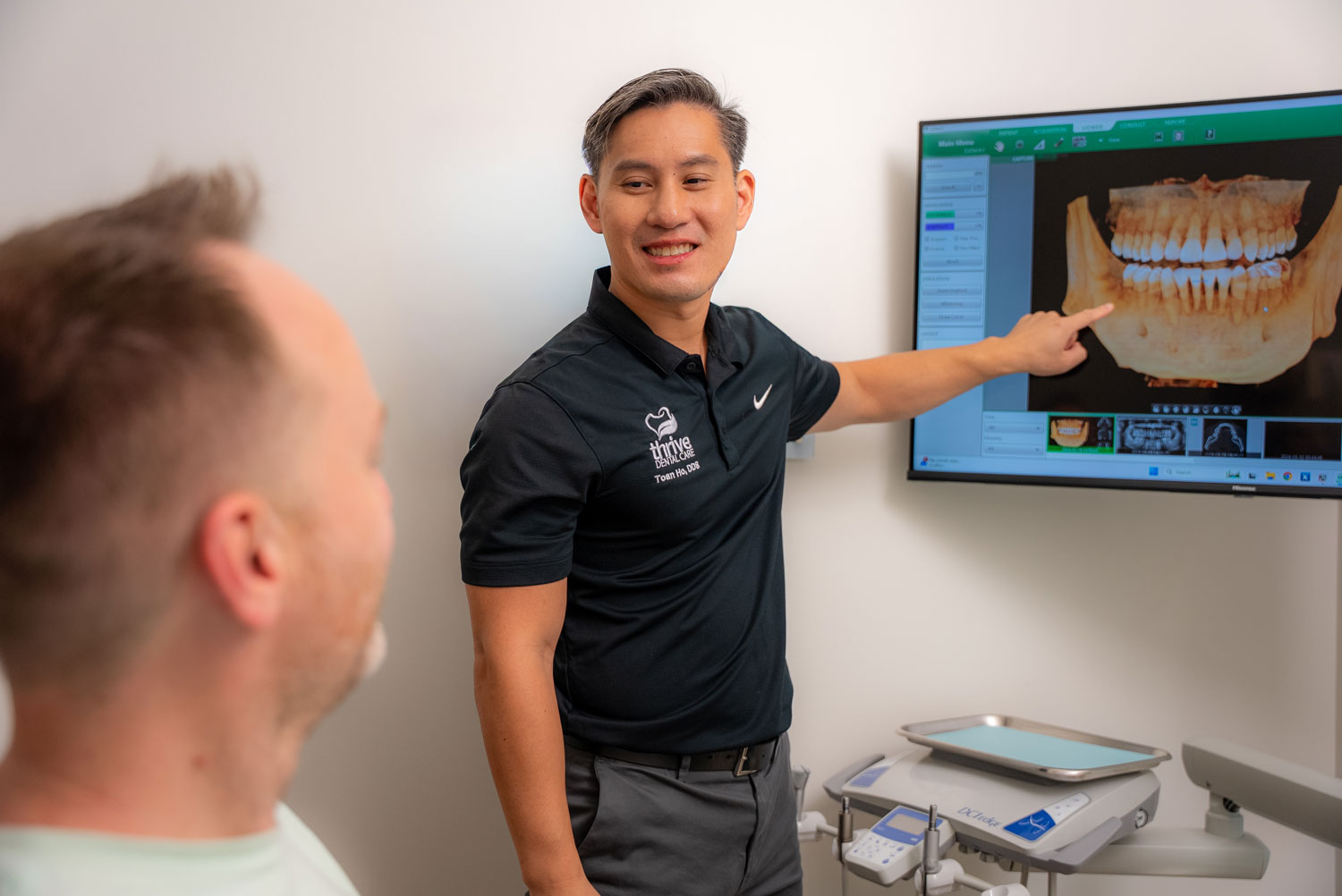 thrive-dental-care-services-nav Jackson Family Dental Dr Jackson reviewing xray with Patient